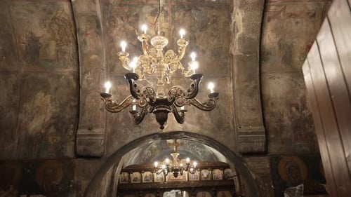 large golden chandelier hanging in an old beautiful church,