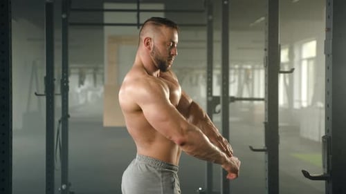 Muscular Man Flexing in the Gym