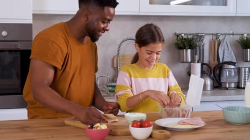Father and Child Making Lunch in Kitchen