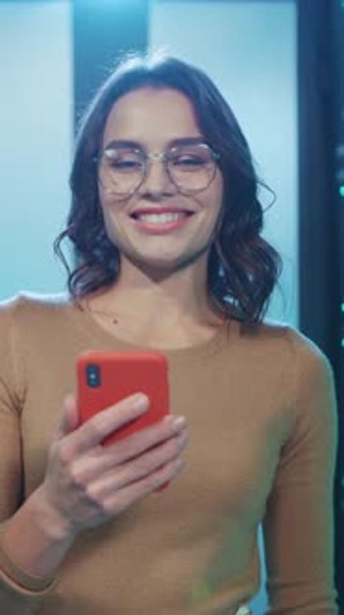 A Young Woman Utilizing Her Smartphone in a Contemporary and Modern Setting Today