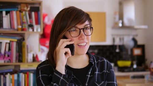 Smiling Woman Talking on Phone Indoors