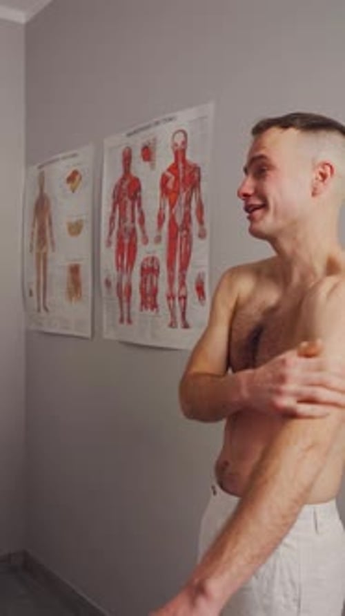 Man Touching Shoulder in Doctor's Office
