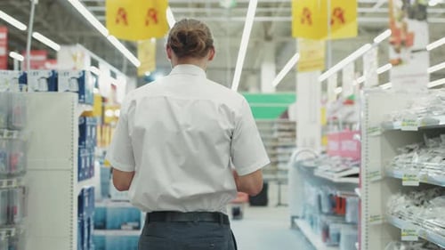Attractive Man the Seller Dances in the Tech Department Use Tablet Computer in Supermarket Feel