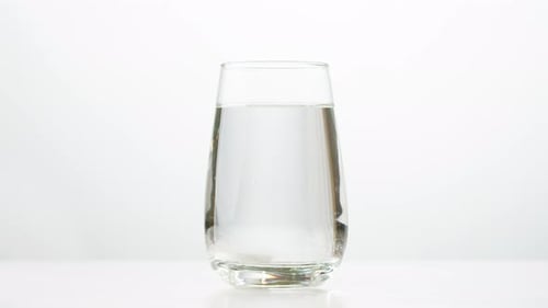 Tablet Dissolving in Glass of Water