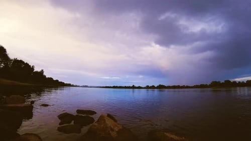 Timelapse of Sunset Over Vistula River in Poland with Lot of Clouds in Sky with Orange Peel Tone and