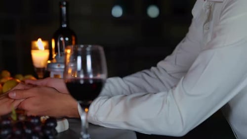Young Man Holding His Girlfriends Hands During a Date on the Terrace in the Evening Romantic Date on