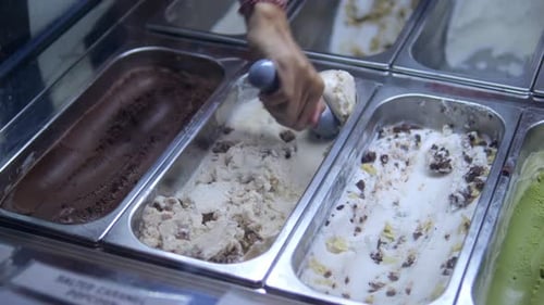 Scooping Ice Cream into a Waffle Cone