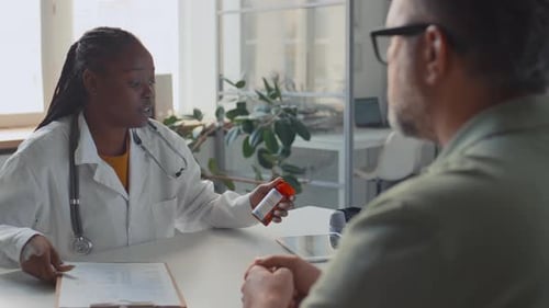 Doctor Explains Medication to Patient in Clinic