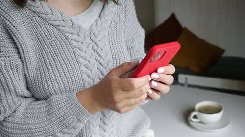 Woman Using Smartphone Indoors with Coffee