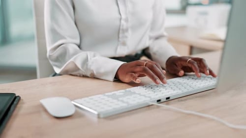 Hands Typing on White Keyboard at Desk