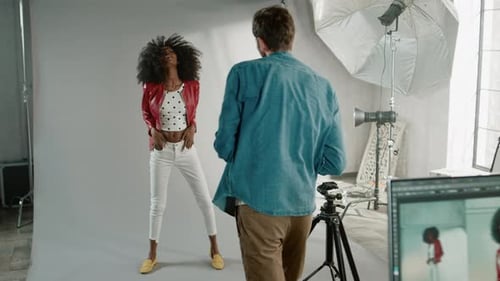 Fashion Model Posing for Photographer in Studio