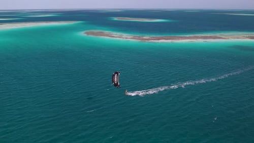 Sailing across the surface of Caribbean ocean waters, Kite surfing