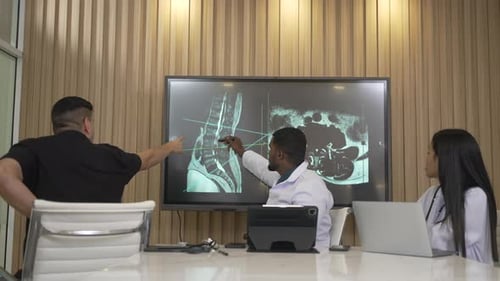 Doctors Discussing Medical Scan in Modern Office