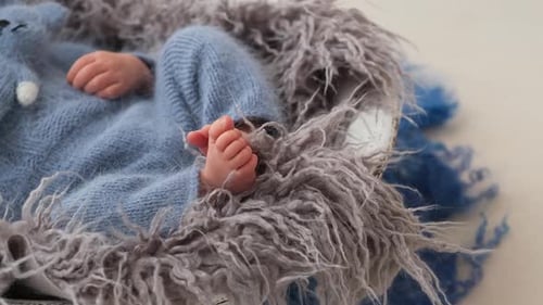 Tiny Newborn Baby Resting Peacefully in Cozy Basket