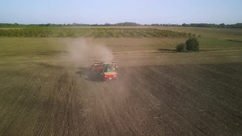 Tractor on the field seeding wheat