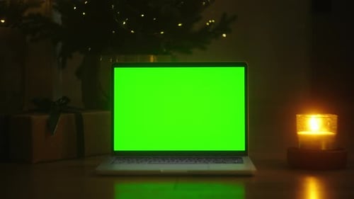 Mesmerizing Scenes Stock Footage of a Dark Room with a Green Screen Laptop and Glowing Candles