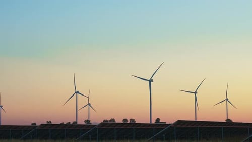 Wind Turbines and Solar Panels at Sunset