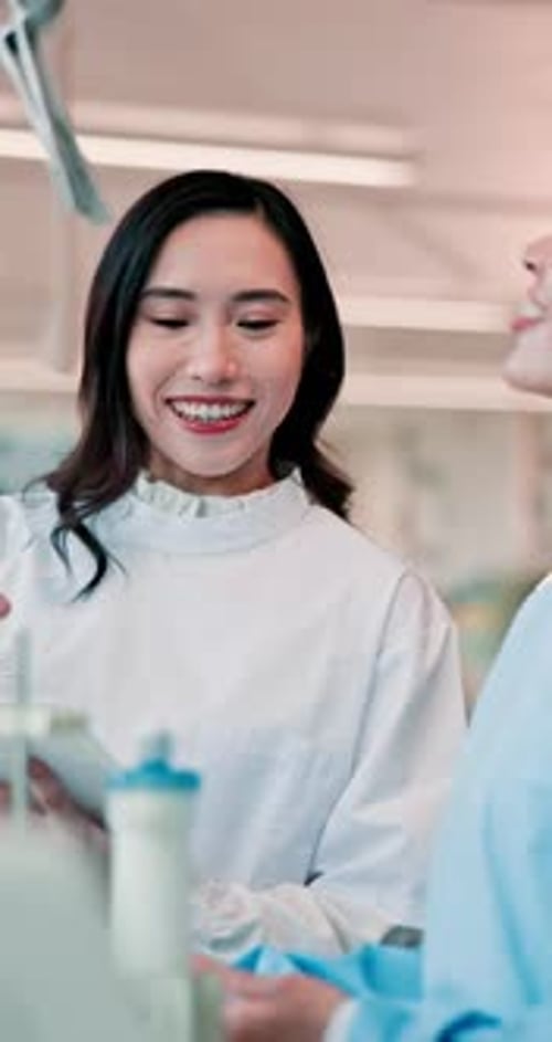 Medical Professionals Reviewing Tablet in Office Setting
