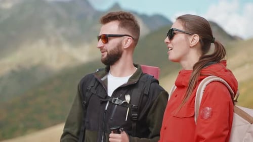 Hikers Trek Through Mountains in the Daytime
