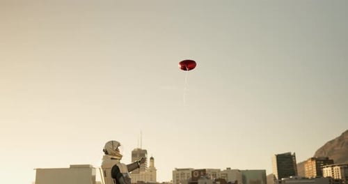 Astronaut, heart and city with balloon in sky for love, space or flying in the air with sunset