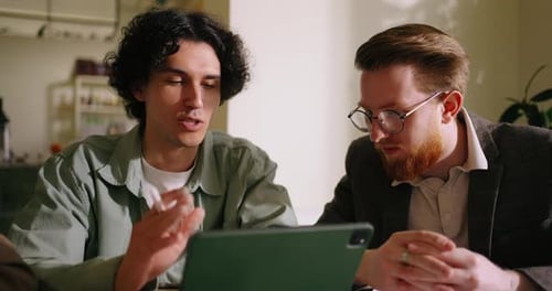 Meeting Of Creative Designer And Business Owners In Coffee Shop Male Freelancer Presenting Project