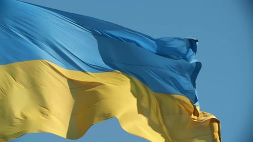Ukrainian Flag Waving Proudly Against Blue Sky