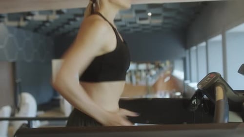 Sporty Woman Running on Treadmill