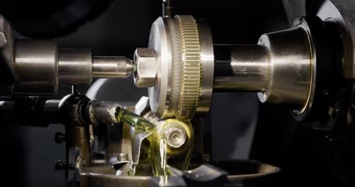 Slow motion macro of specialist is working on production of different gearing details in a worksho