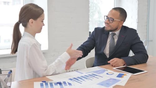 Business People Meeting to Shake Hands in Office