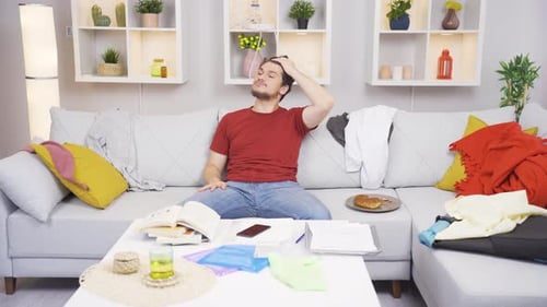 Man Sitting on Sofa Lost in Thought Indoors