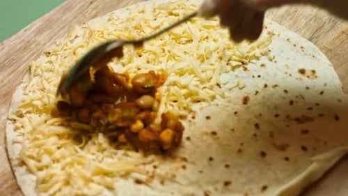 Preparing a Savory Quesadilla with Cheese and Beans