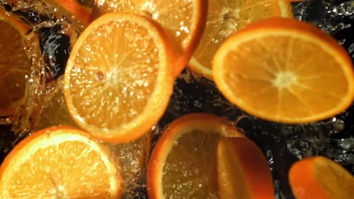 Sliced Orange Circles Fall Into the Water Filmed on a Highspeed Camera at 1000 Fps