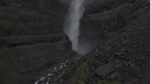 Majestic Waterfall in Iceland's Rugged Terrain