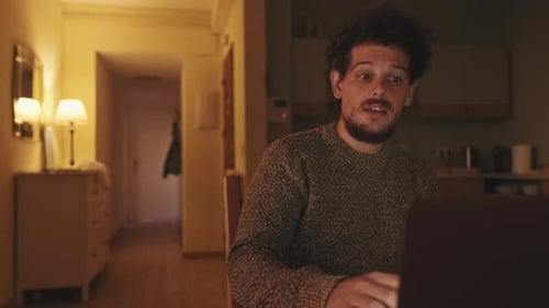 Young Adult Man Video Calling At Home Night