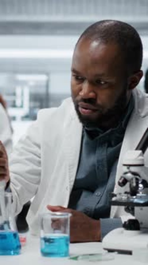 Scientist Using Pipette With Beaker in a Lab