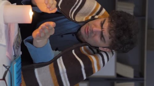 Man Counting Money by Candle Light Indoors