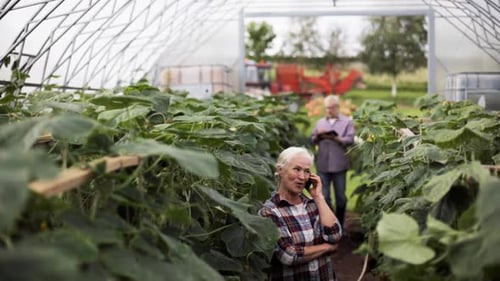 Senior Woman Talking on Phone in Greenhouse