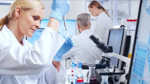 Female Scientist Working in Bright Modern Laboratory