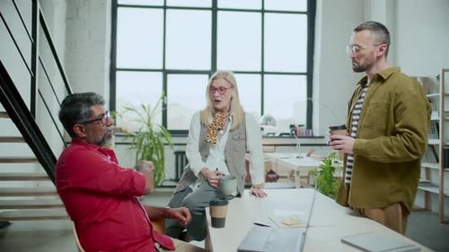Group of Diverse Colleagues Chatting during Coffee Break in Office