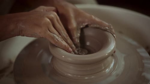Hands Shaping Clay on Pottery Wheel