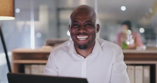 Businessman, happy and face by laptop in office, professional and technology in confidence at work