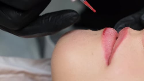 Lip Blush Application by Cosmetologist Close Up