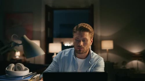 Focused Guy Drinking Tea at Dark Place Closeup