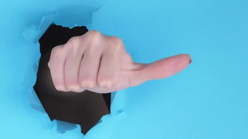 Hand Giving a Thumbs Up Through Blue Paper
