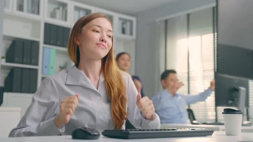 Young Caucasian businesswoman dance with music while working in office.