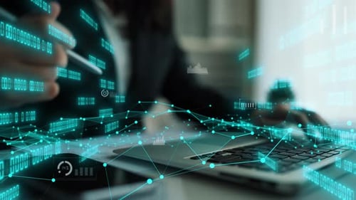 Professional Working with Financial Data Overlays on Laptop