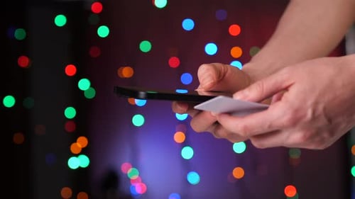 Closeup of a Girl Entering Card Details on the Phone Online Purchase Concept