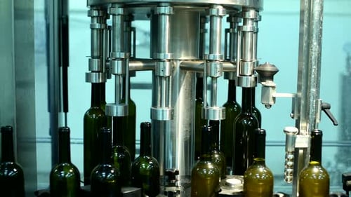 Wine Bottle Conveyor System Processing During Manufacturing at a Beverage Facility