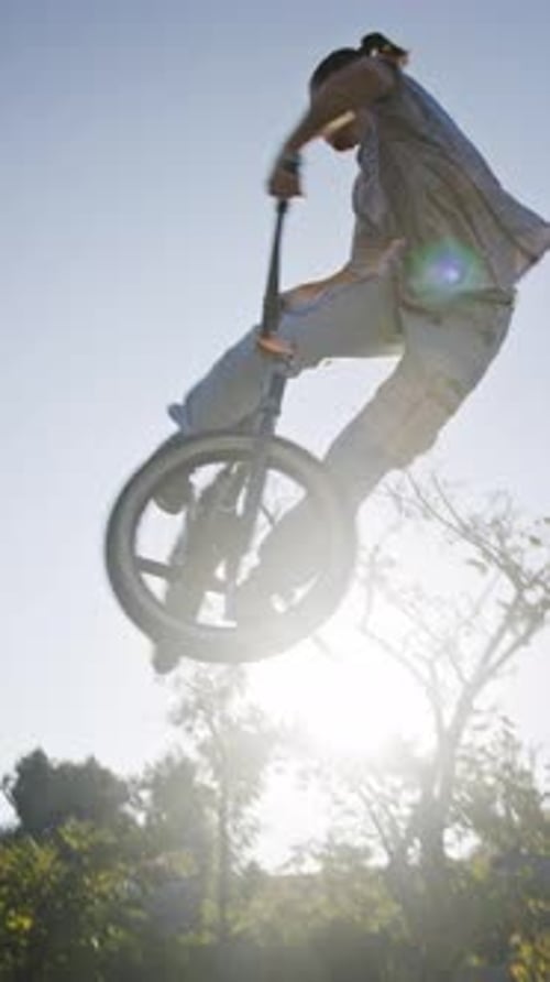 Young Man Performing BMX Stunt in Skate Park