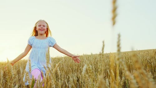 Blonde Child with Long Hair Runs Across a Field